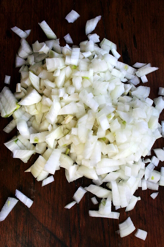 Chopped onions on a board. 