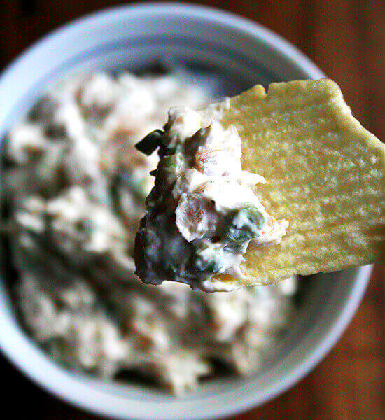 A bowl of real sour cream and onion dip aside Ruffle potato chips