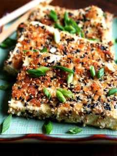 Pan-fried tofu with nuoc cham on a platter.