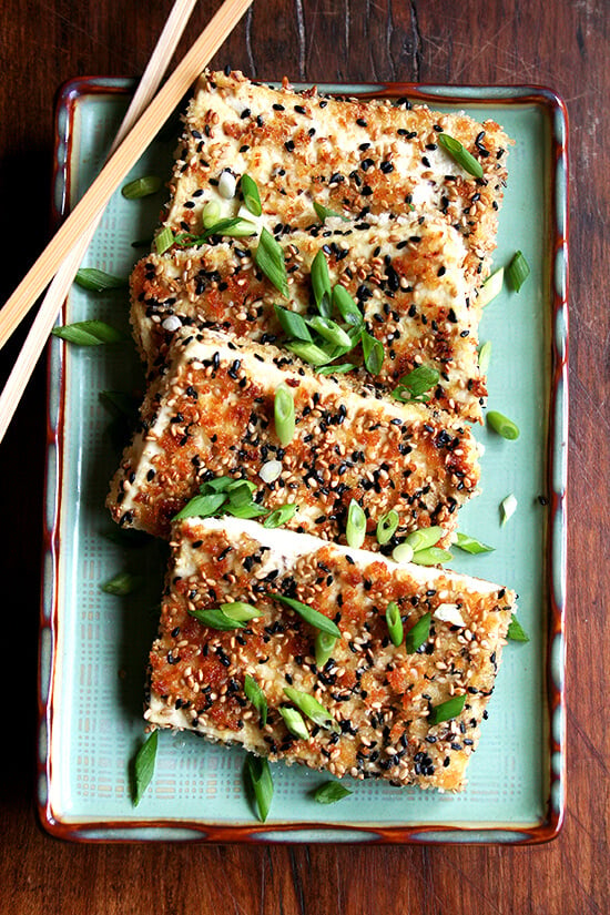 pan-fried sesame-crusted tofu on a platter