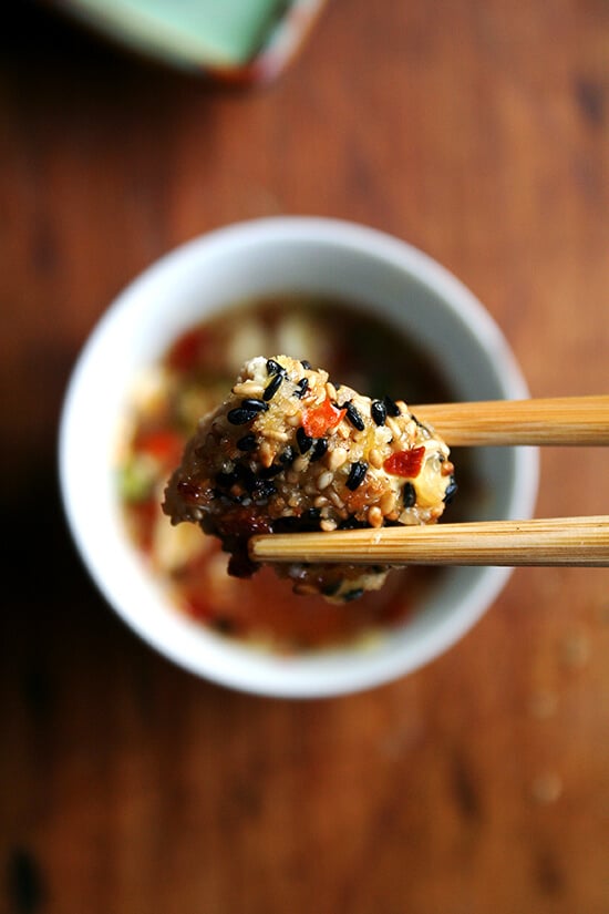 A bite of sesame-crusted tofu with nuoc cham.