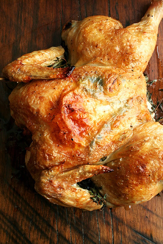 A spatchcocked chicken on a board.