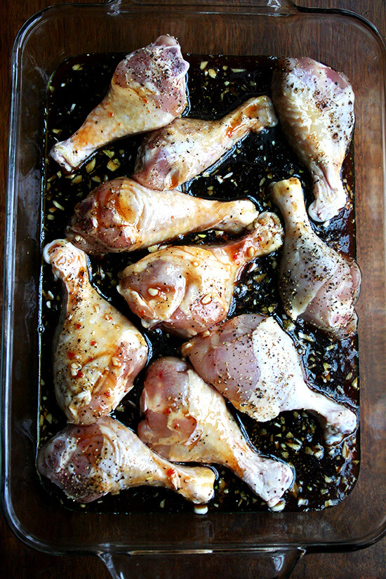 A 9x13-inch pan filled with chicken drumsticks and honey-soy sauce mixture