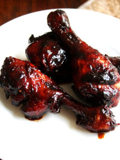 A plate of oven-baked, honey-soy chicken drumsticks.