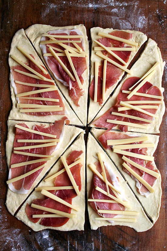 Croissant dough, rolled out, cut into triangles, top with slices of smoked ham and cheese.