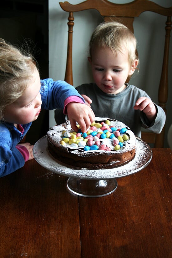 This rich chocolate Easter egg nest cake is festive and fun, puffing way up when it bakes and sinking when it cools, a crackly meringue-like layer forming a perfect base to house dozens of colorful candy eggs. // alexandracooks.com