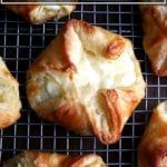 A cheese danish cooling on a wire rack.