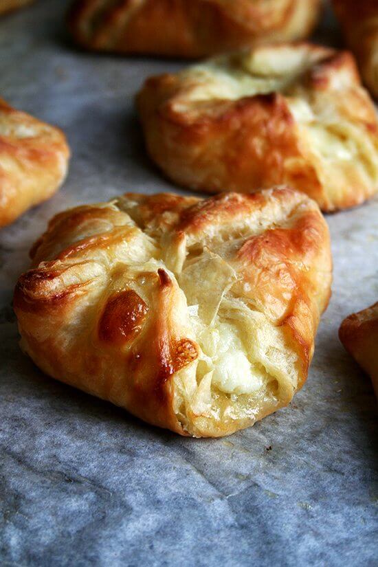 An up close shot of cheese Danishes on the baking sheet.