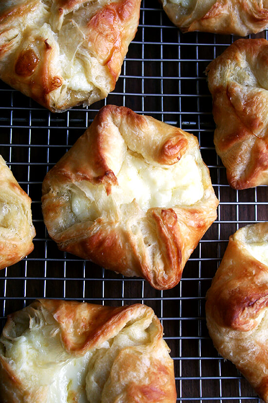 An overhead shot of ricotta-filled cheese Danishes cooling on a rack.