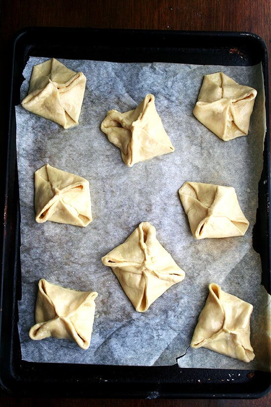 Eight egg washed cheese Danishes, ready for their last rise.