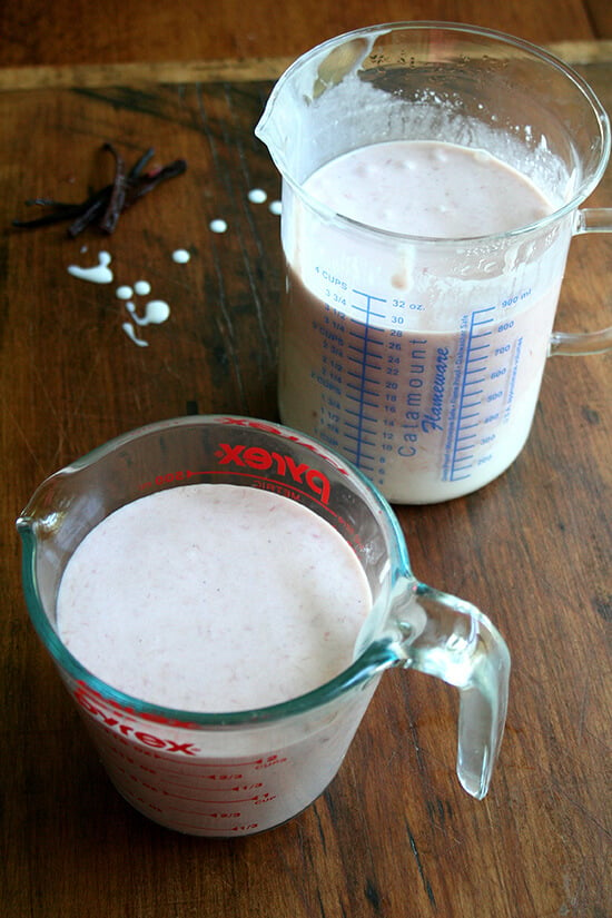 Rhubarb ice cream base in two liquid measuring cups. 