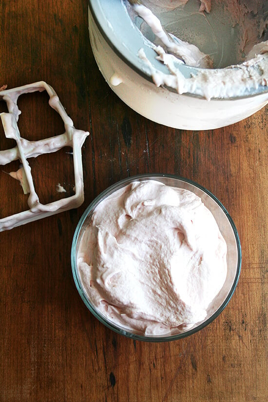 Freshly churned rhubarb ice cream aside Kitchen Aid ice cream maker. 