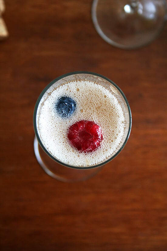 Mixing up the peach base for this sparkling cocktail takes no time, and if you happen to have some red, white or blueberries on hand, nothing could be more festive. // alexandracooks.com
