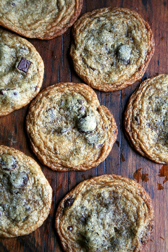 Thin and chewy chocolate chip cookies on a board. 