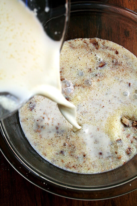 Pouring the milk mixture into the oat mixture for the baked steel cut oatmeal.