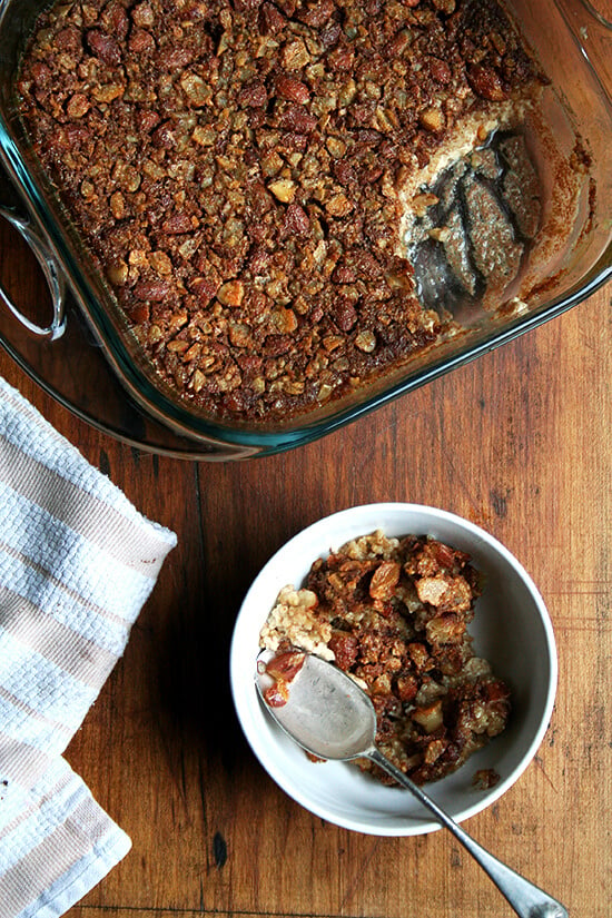 Pan of baked steel cut oatmeal aside a bowl of the freshly baked oats. 