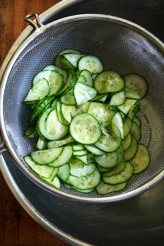salted cucumbers, draining