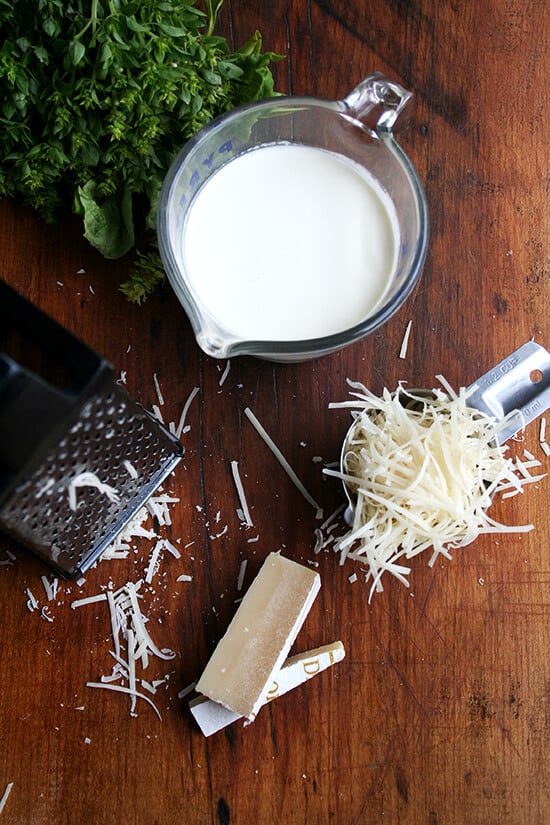 Overhead view of cream and shredded Parmigiano