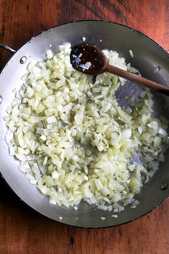 Overhead view of sweating the onions and garlic in an everyday pan.