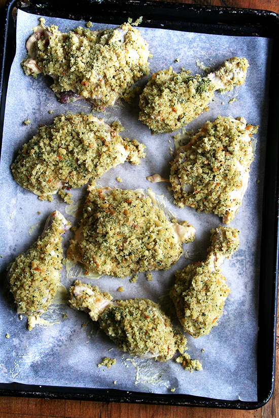 Chicken thighs and drumsticks, coated with herbed bread crumbs, ready for the oven.