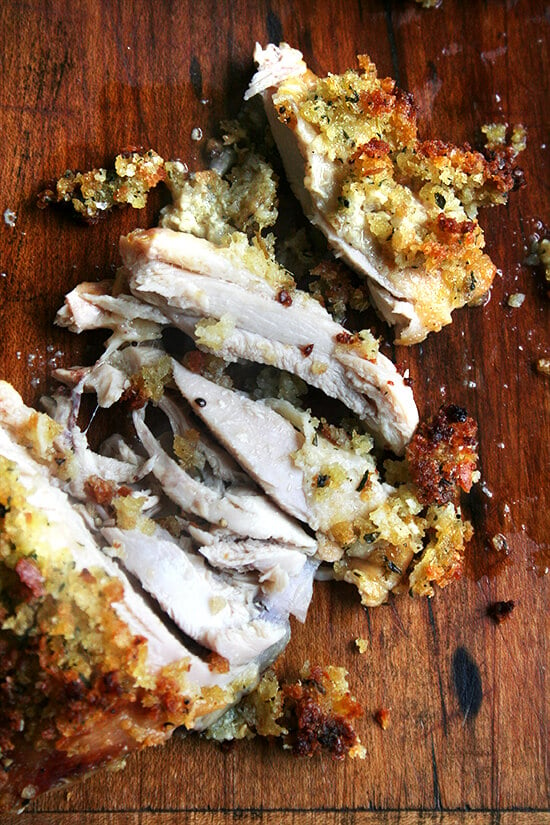 Dijon mustard roasted bread crumb chicken, cut on cutting board. 