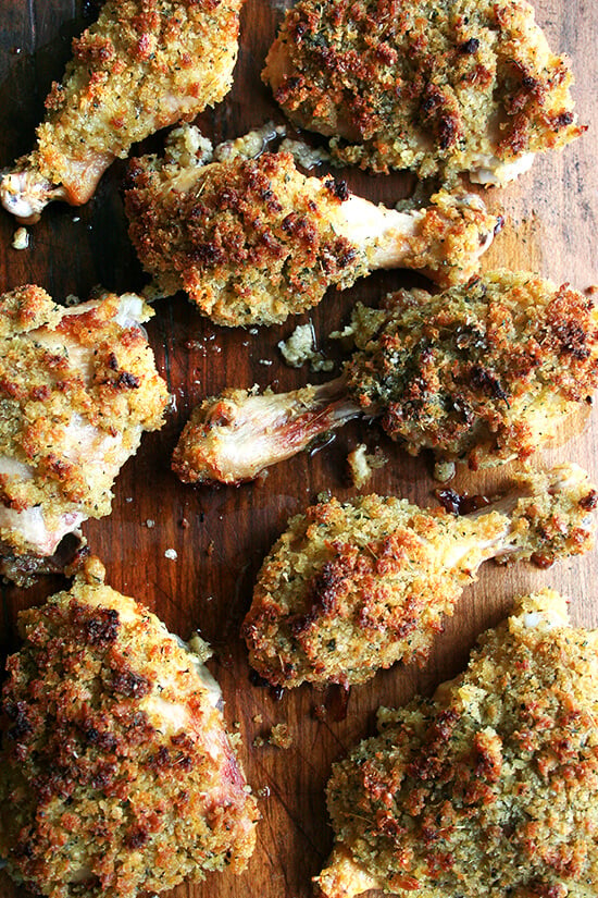 Dijon mustard roasted bread crumb chicken, resting on a cutting board.