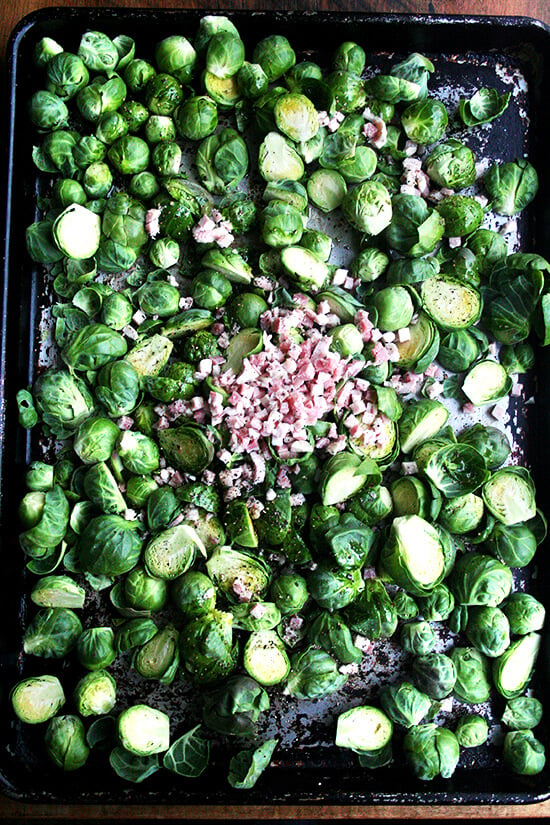 Brussel sprouts and pancetta on a sheet pan ready for the oven