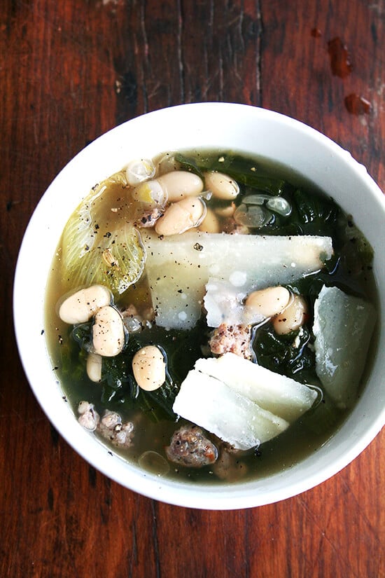 A bowl of white bean, sausage, and escarole soup.