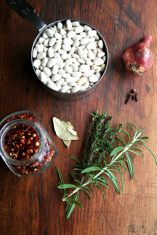 A board of dried beans and herbs.