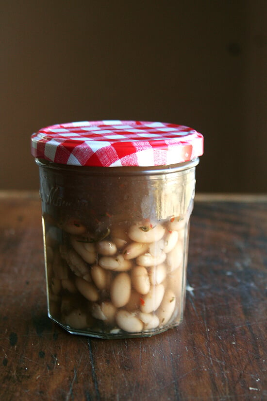 cooked white beans stored in cooking liquid