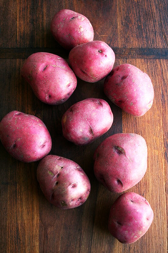 red potatoes on a cutting board 