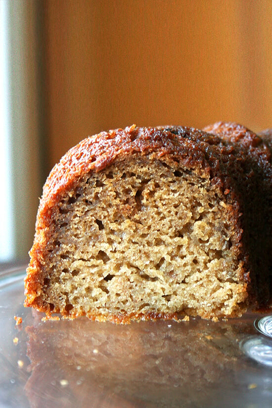 Sliced applesauce - yogurt cake on a cake platter.