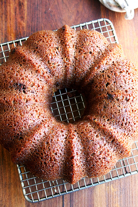 Baked applesauce-yogurt cake on a cooling rack.