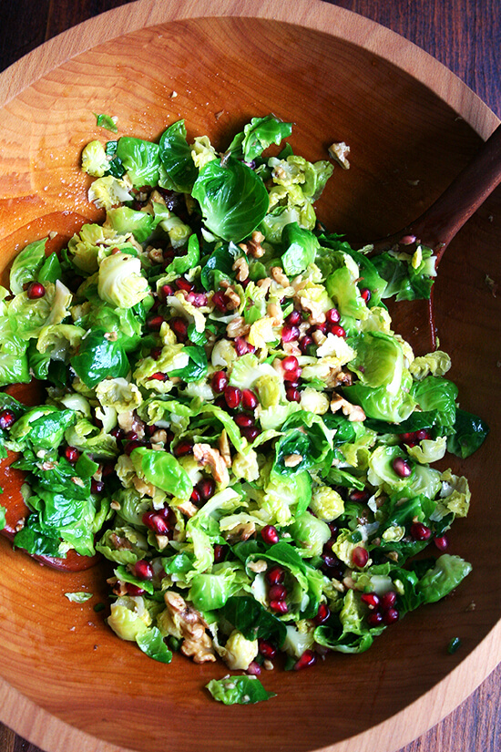 This brussels sprout salad, an amalgam of flavors and textures — sweet brussels sprouts, spicy jalapeños, crisp and tart pomegranate seeds, and crunchy toasted walnuts — will add a spot of color and a touch of freshness, a perfect counter to the creamy potatoes and the buttery bird on the Christmas dinner table. // alexandracooks.com