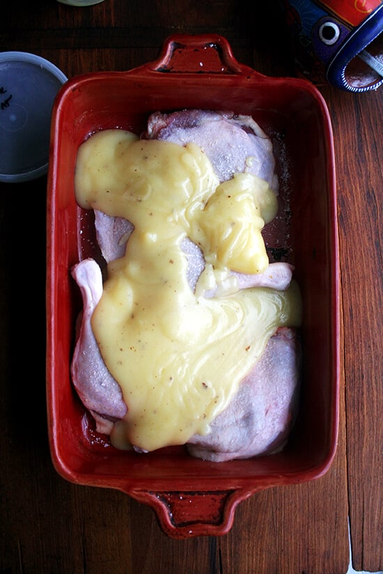 A 9x13-inch baking dish filled with 4 duck leg confit, salt, and duck fat. 