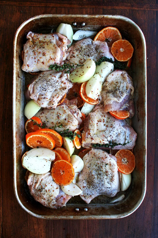 A roasting pan filled with sauced chicken and vegetables.