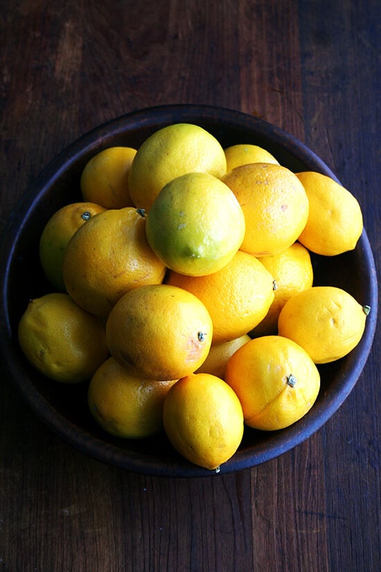 meyer lemons in a wooden bowl.
