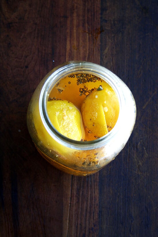 An overhead shot of preserved lemons à la bon appetit in a jar. 