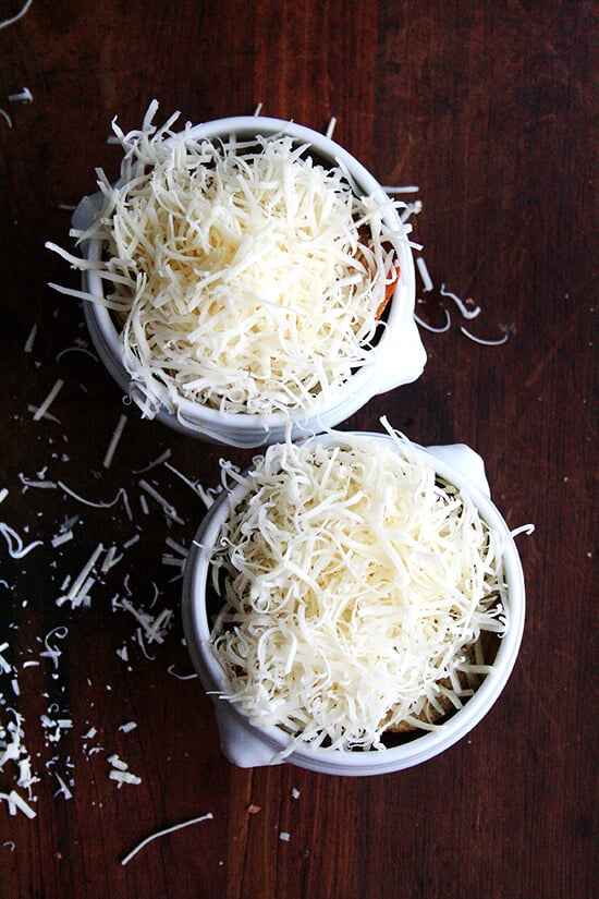 Two bowls of French onion soup topped with bread and cheese.