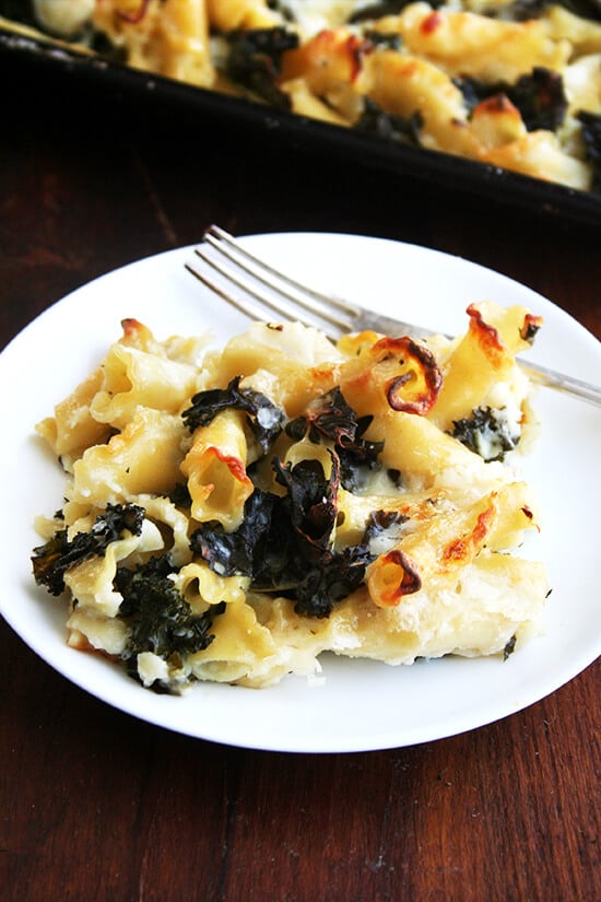 A portion of sheet pan pasta gratin with kale on a plate.