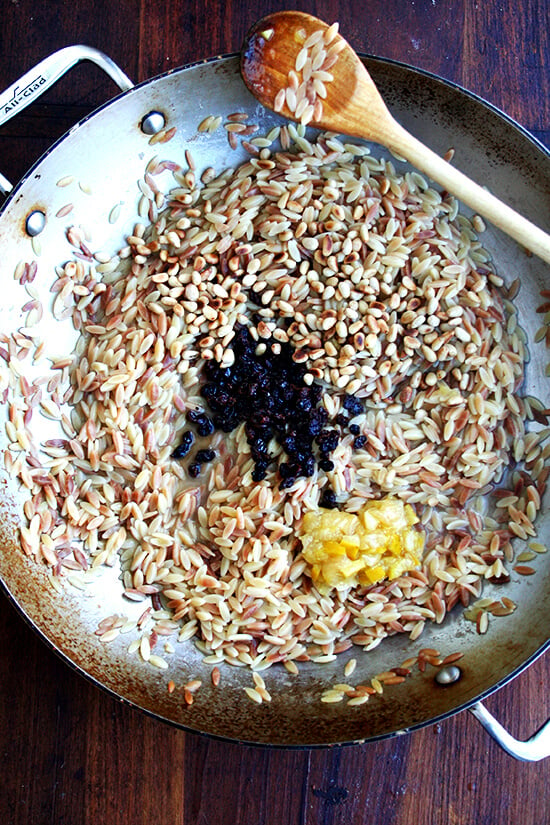 adding the currants, preserved lemon and toasted pine nuts