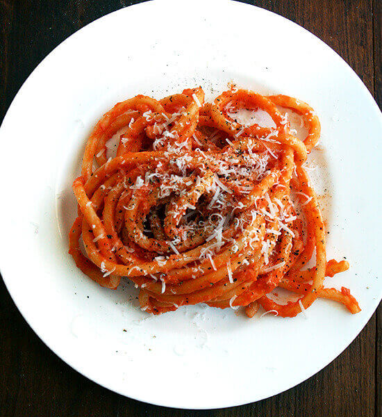 A plate of bucatini tossed with butter-roasted tomato sauce.