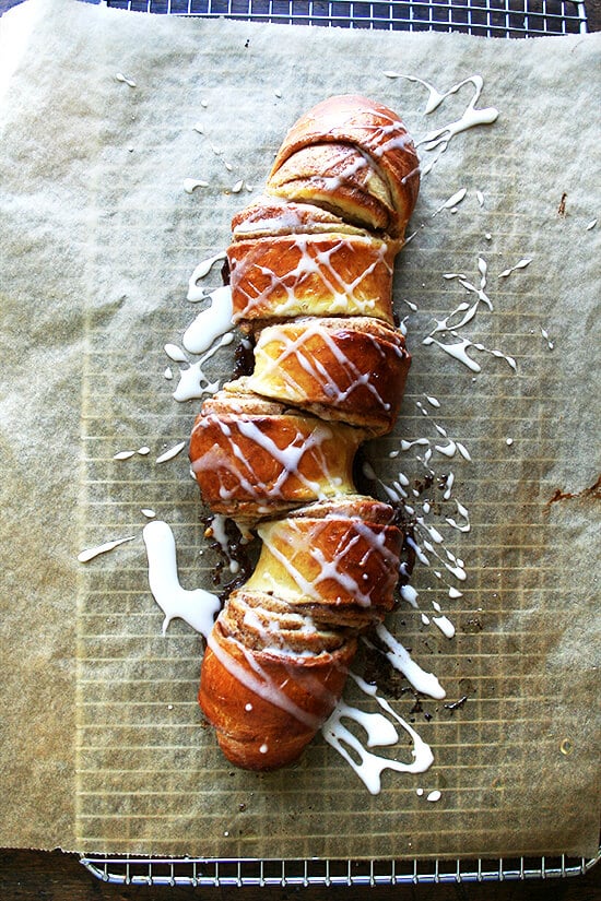 Cinnamon pull-apart bread, freshly baked, drizzled with icing. 