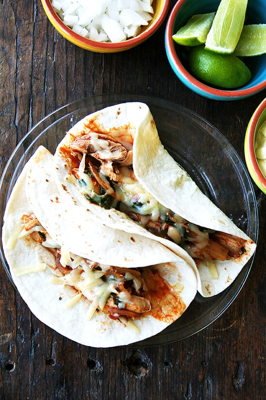 A plate of 2 tinga tacos.