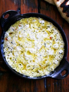 A cast iron skillet filled with baked ricotta.