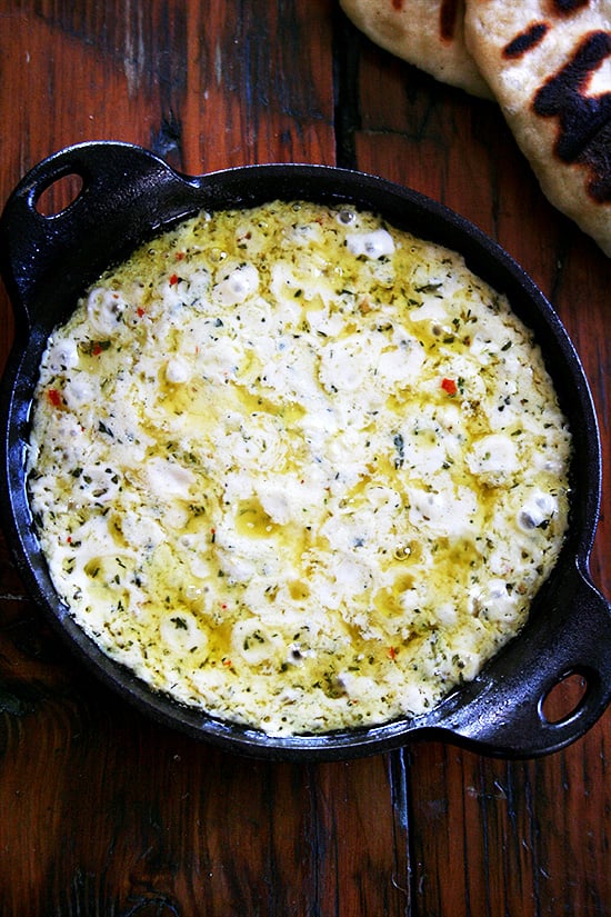 A cast iron skillet filled with baked ricotta.