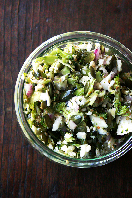 An open weck jar packed with the cauliflower-broccoli salad. 