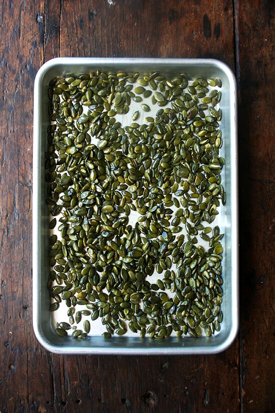 A sheet pan holding pumpkin seeds. 