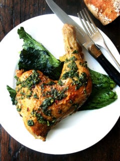 A plate of crispy roast chicken with herb sauce.