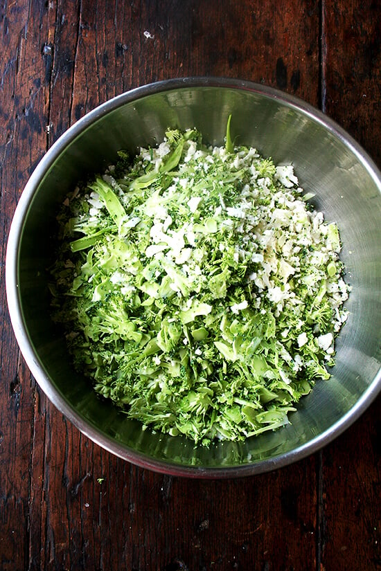 A large bowl filled with shredded cauliflower and broccoli.